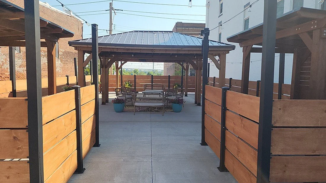 Outdoor patio and pergola next to the private pickleball court at Your Boutique Hotel