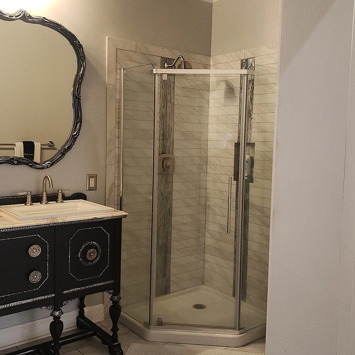 The master suite bathroom shower at Your Boutique Hotel with marble tile