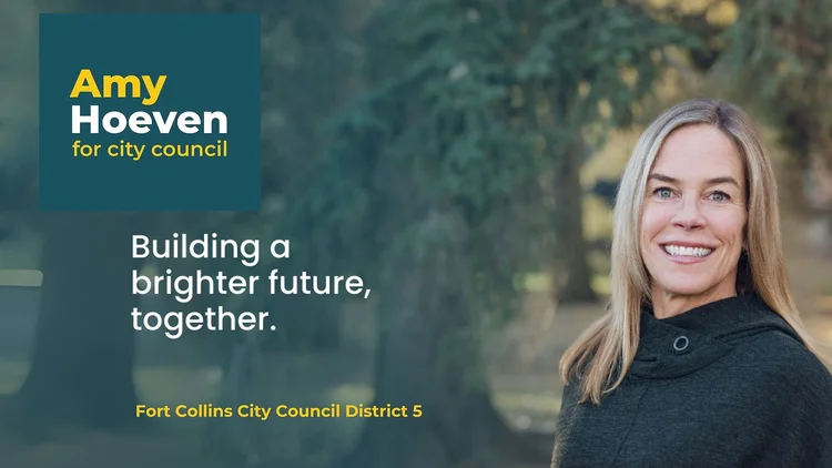 Photo of a woman standing outside in front of large trees.