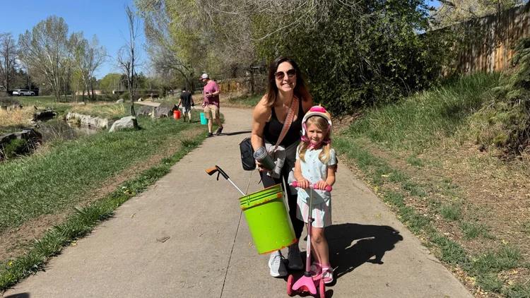 Photo of a woman and a young girl on a trail.