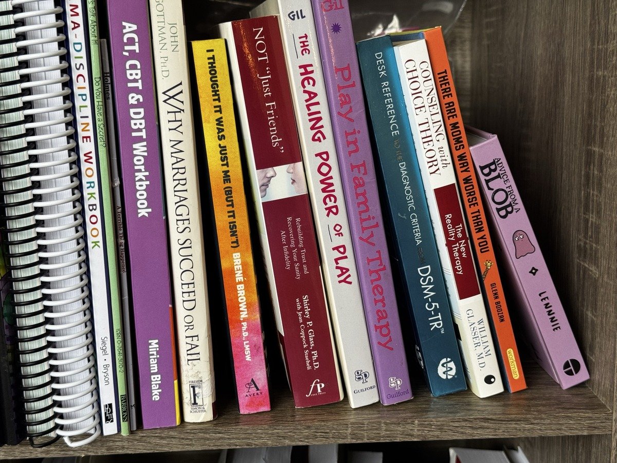 Bookshelf of couples and relationship therapy texts at Brain & Heart Healing, Abilene TX