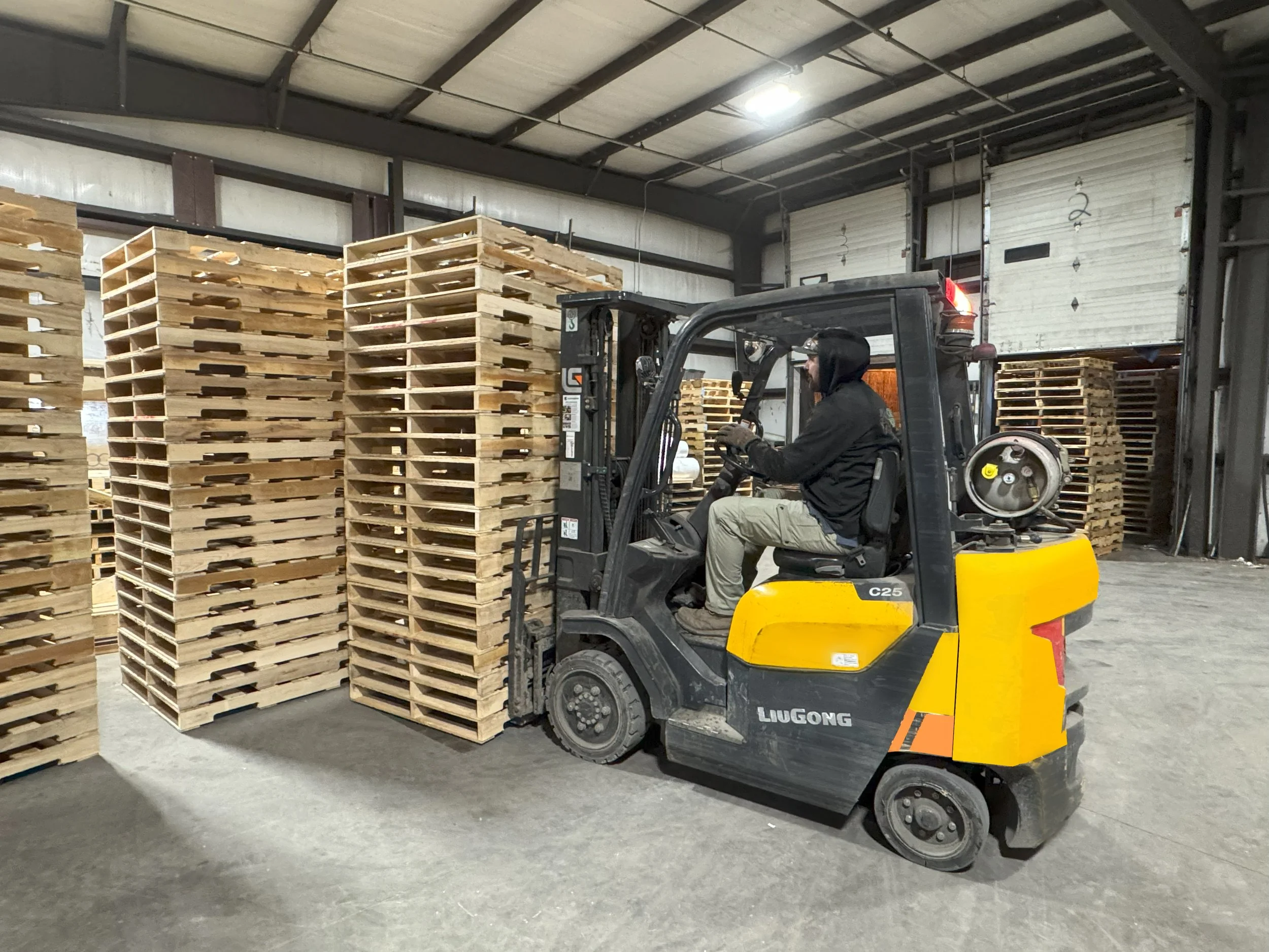 Forklift moving pallets inside a warehouse
