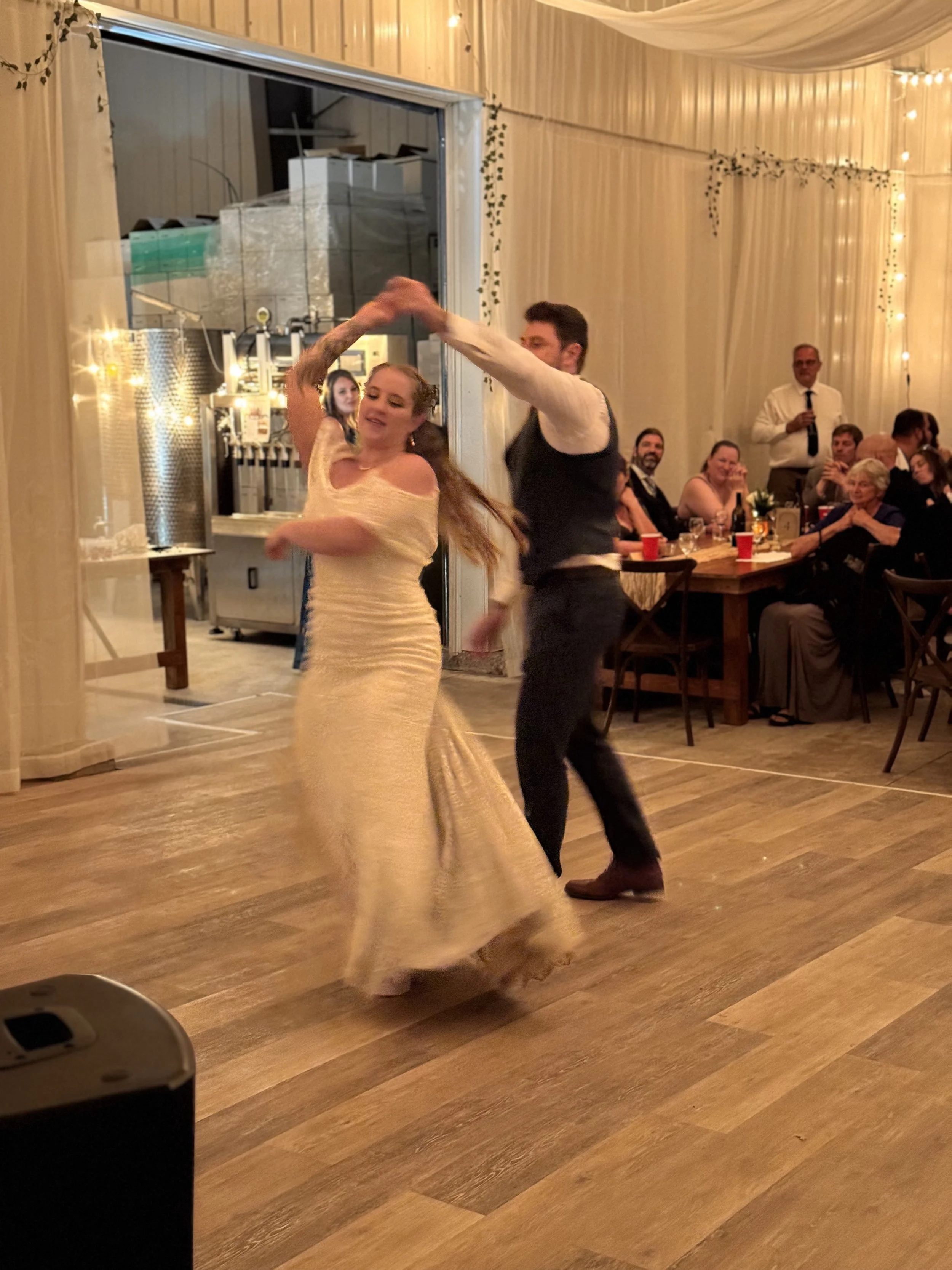 Bride and groom dancing inside the winery reception space