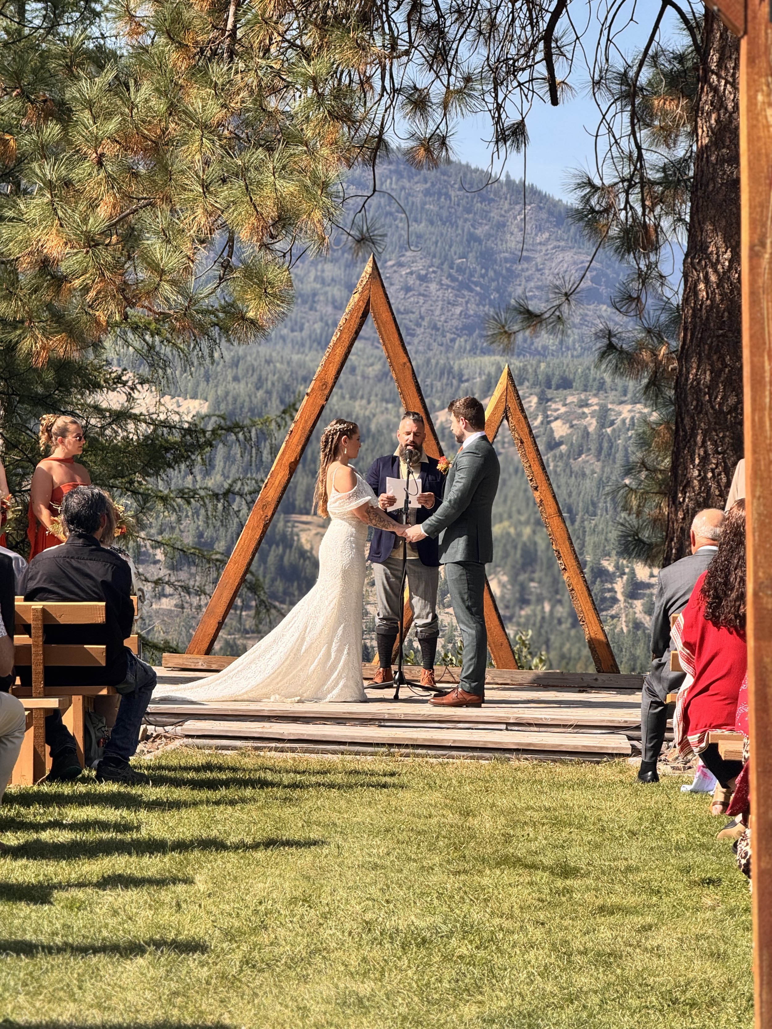 Bride and groom exchanging vows against the mountain backdrop