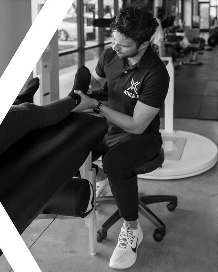 AthleX coach performing a mobility assessment with a chronic pain client in Austin, TX