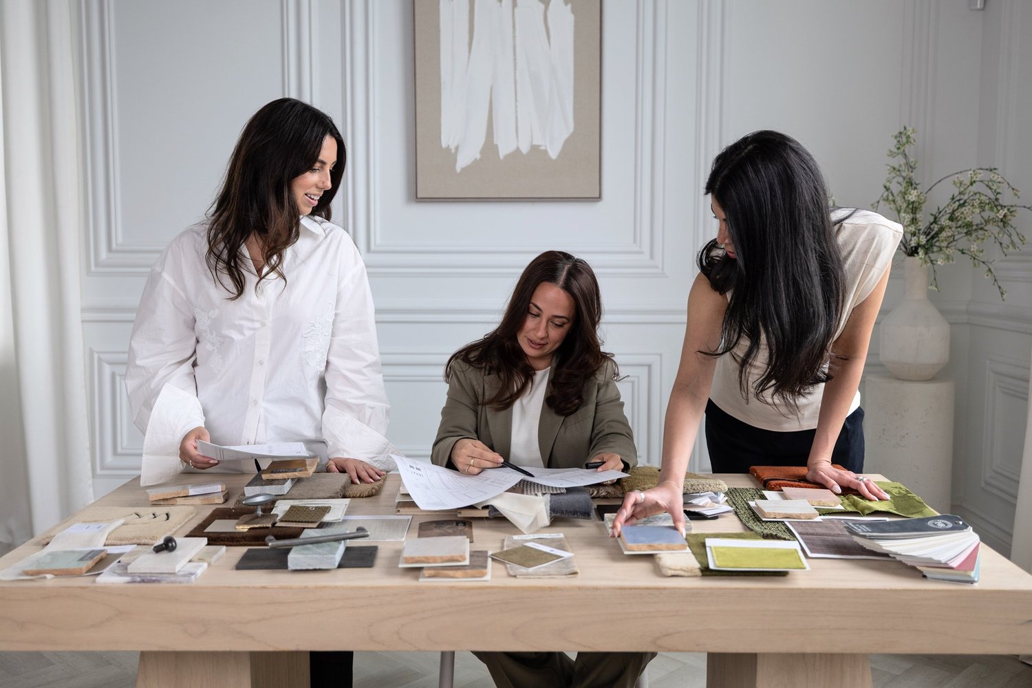 Interior designers reviewing fabric and finish samples together