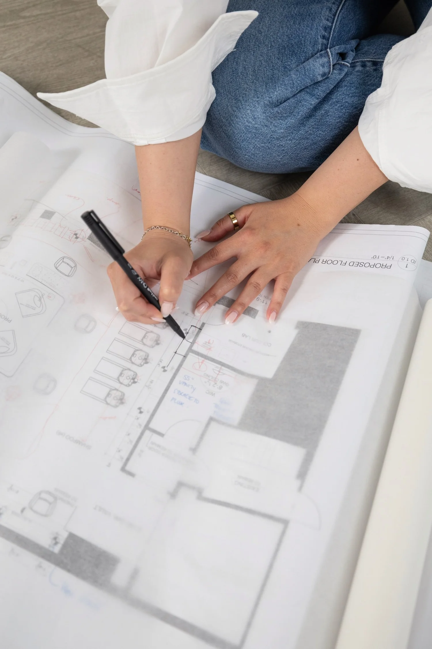 Close-up of hands drawing on interior design plans