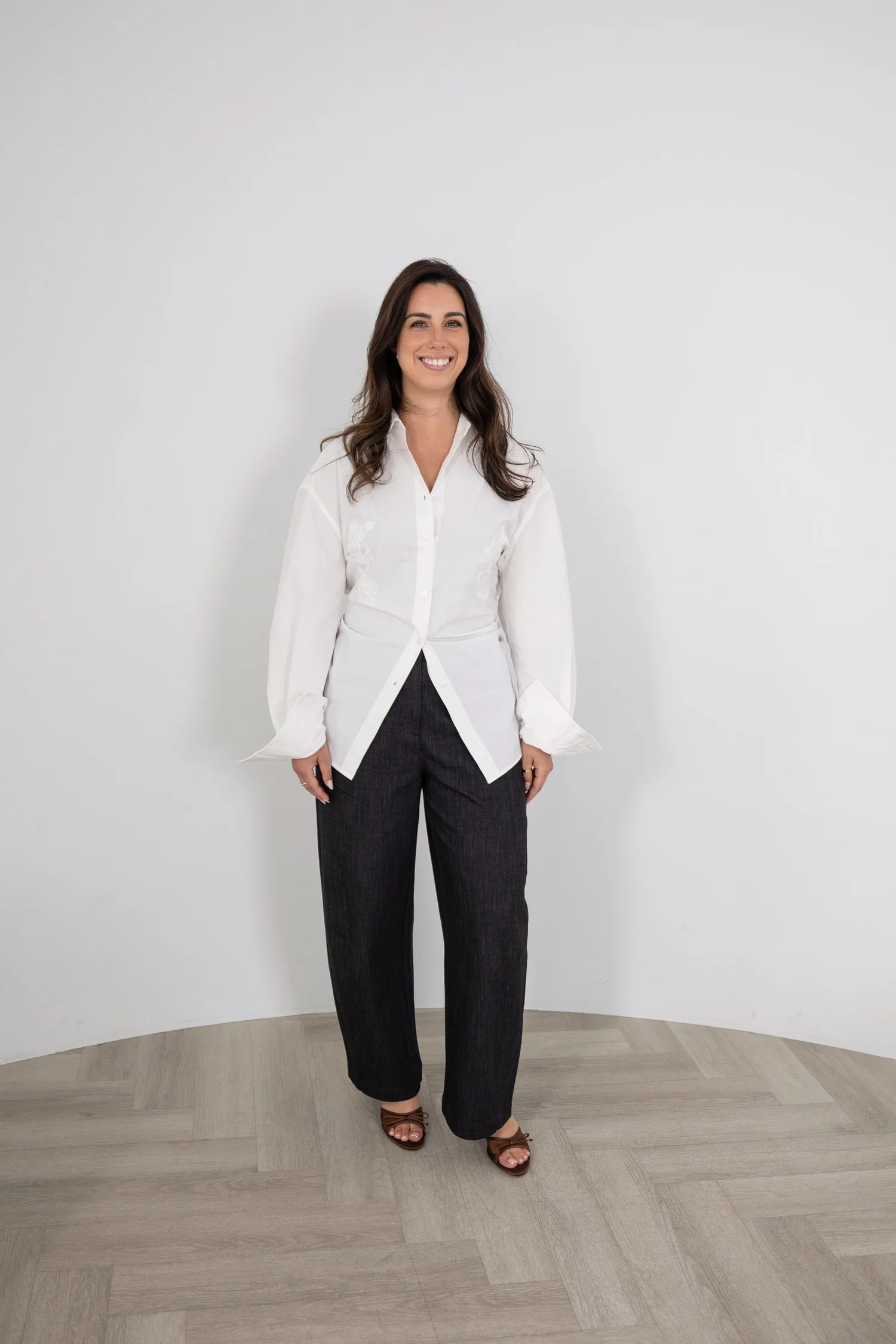 Standing portrait of a designer in a white blouse