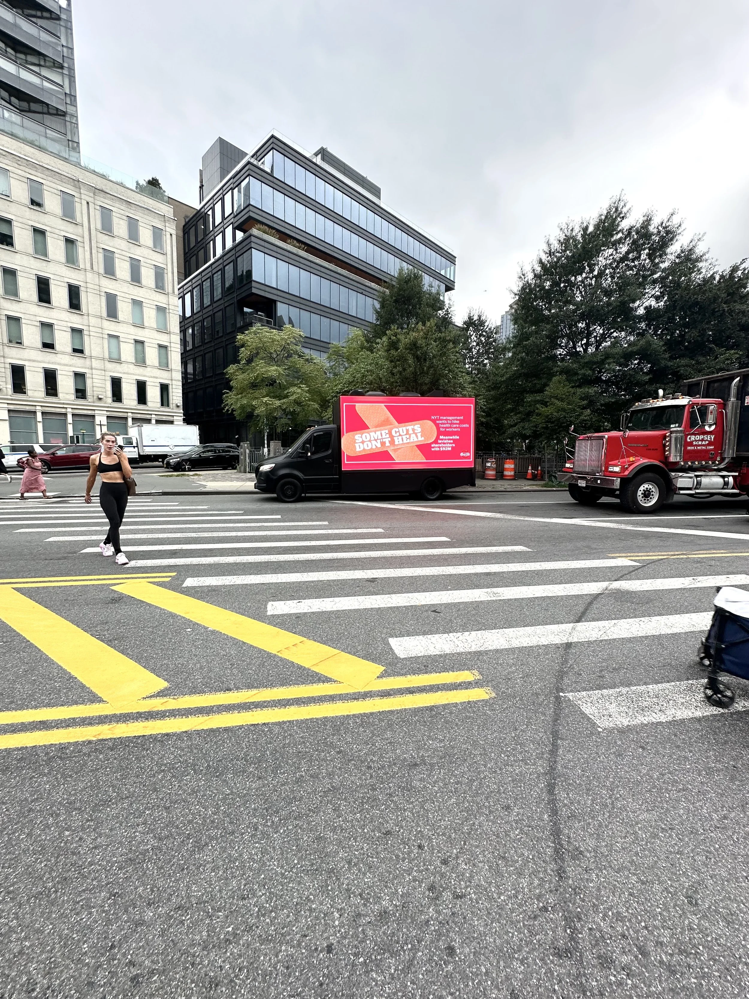 Mobile billboard truck creative in New York reading What Matters More, comparing CEO compensation to worker health care funding