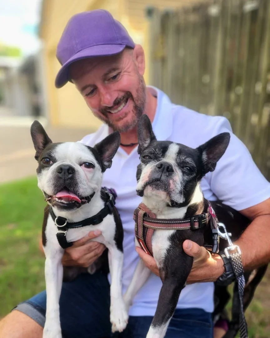 Kelly, Brisbane dog walker and founder of The Dog Adventure Co, with a client dog in Bulimba