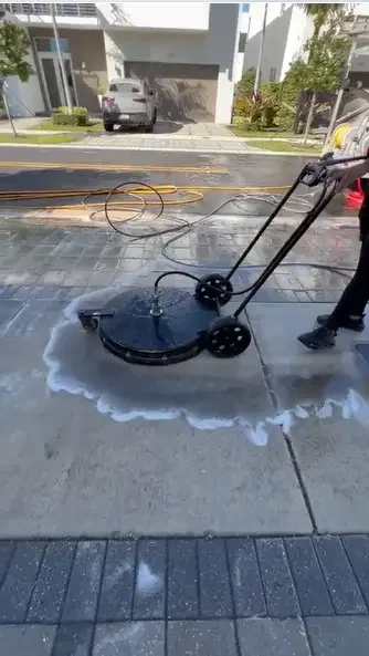 Surface cleaner pressure washing a residential driveway in Miami