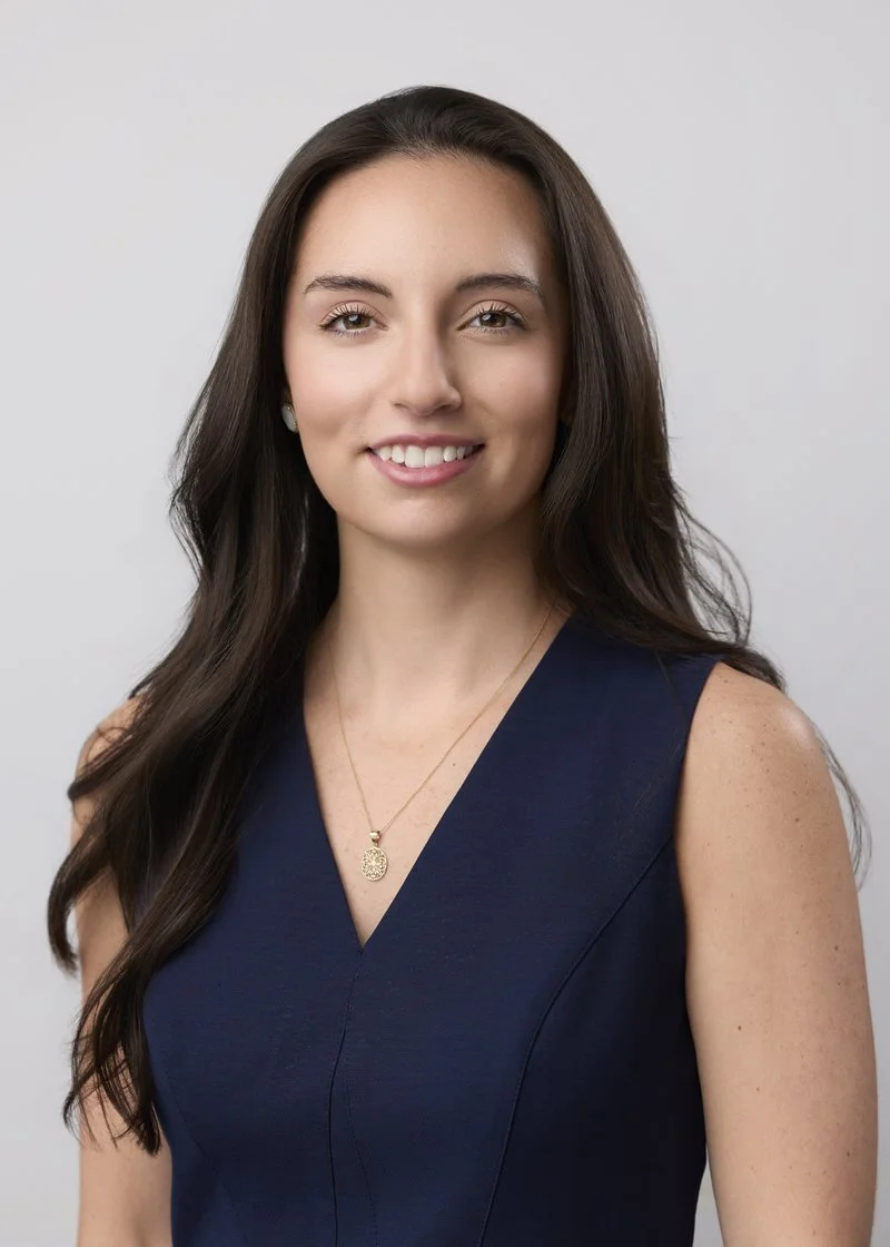 Residency headshot of a woman in a navy dress, Wilmington, NC.