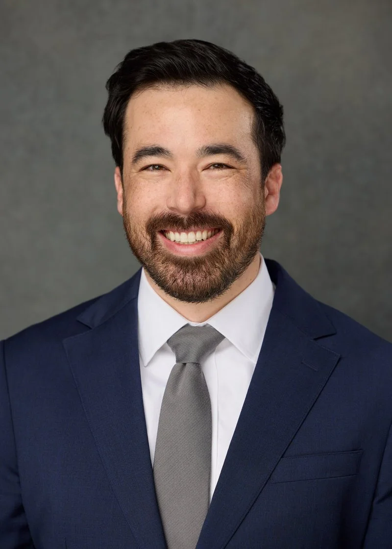 Residency headshot of a man in a navy suit and tie, Wilmington, NC.