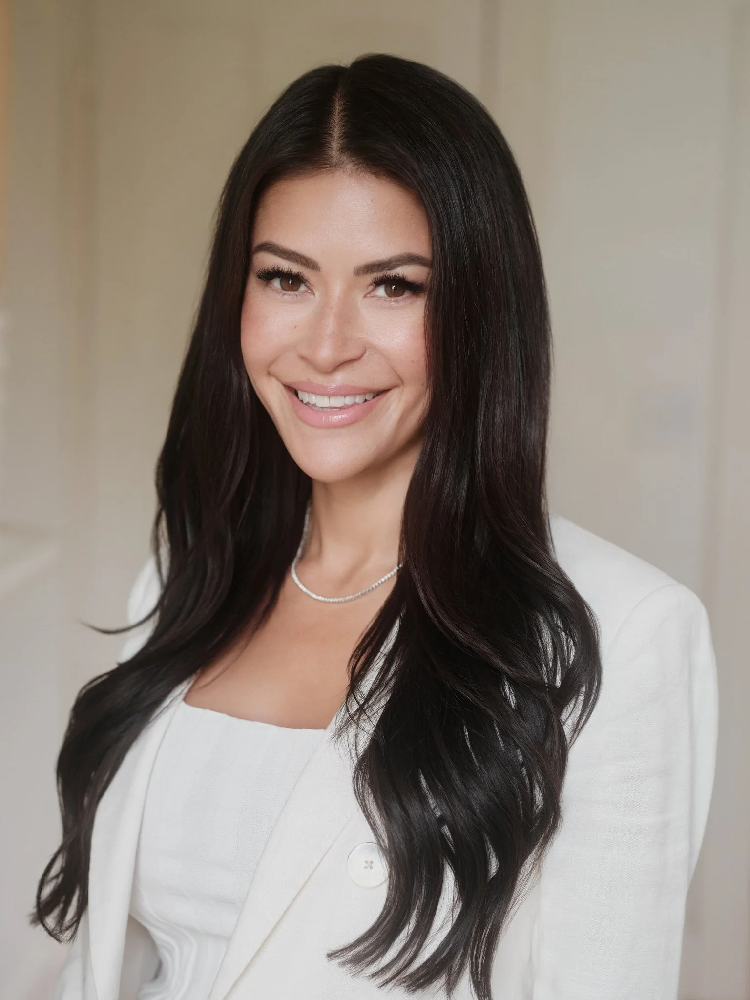 Professional headshot of a woman in a white blazer, Wilmington, NC