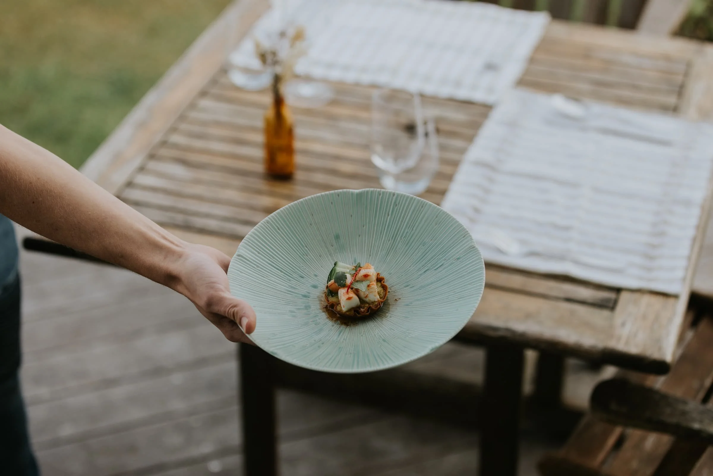 Private chef Jethro Copedo plating a dish at an in-home dining experience on the Sunshine Coast