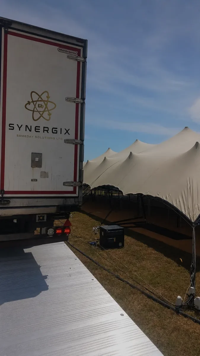 Synergix refrigerated trailer beside an event marquee