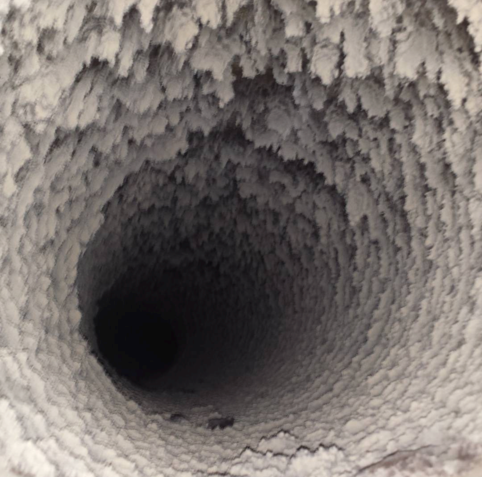 Extreme case – severely clogged round duct packed with lint after years without filter changes