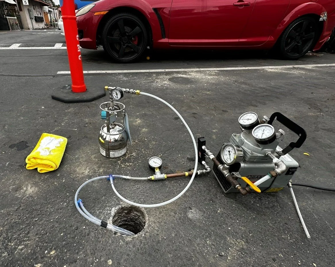 Sub-slab soil vapor sampling through asphalt pavement at a commercial site using vacuum pump and Summa canister for UST contamination investigation