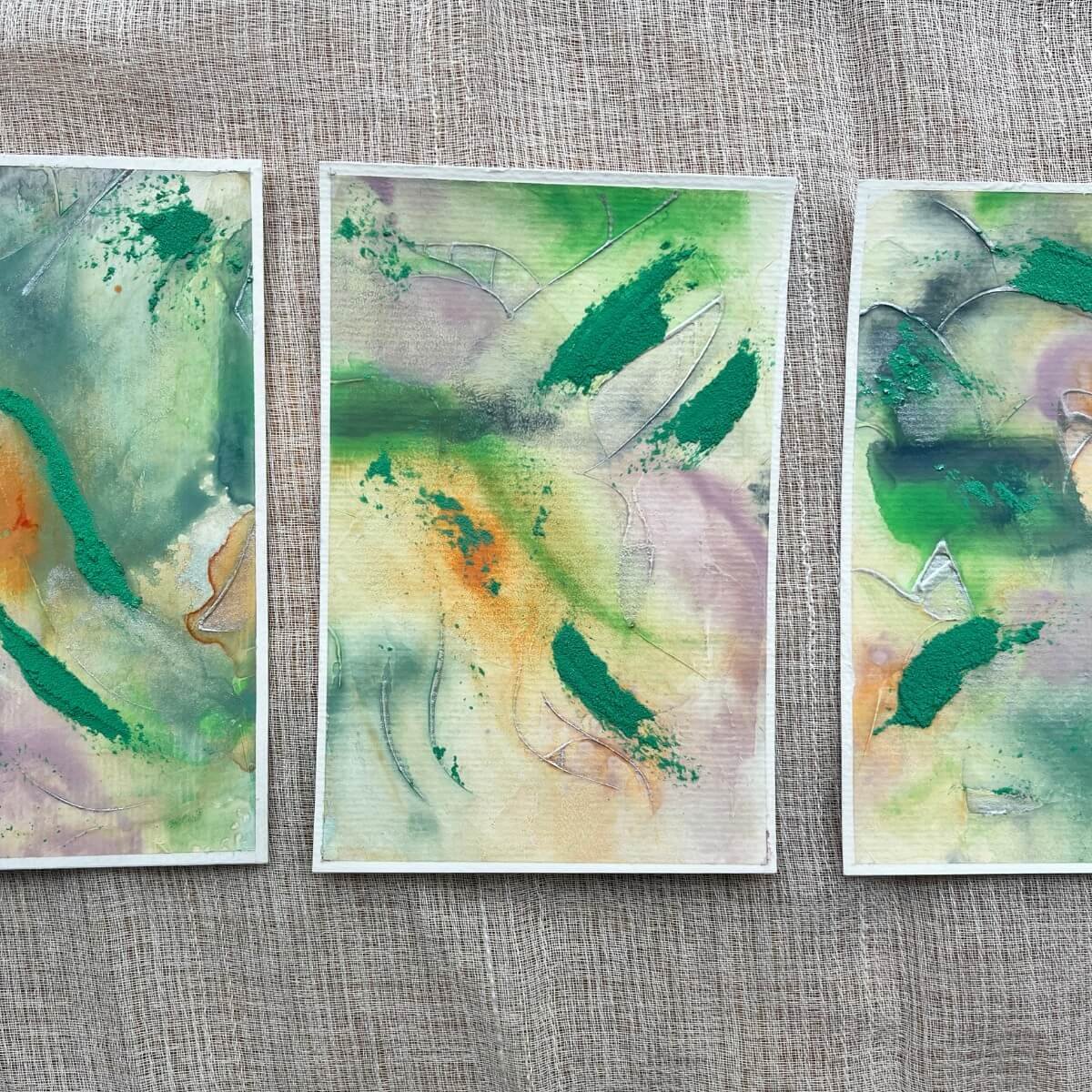 Three artworks from the “Silver Feathers Rising” series – vibrant greens with soft pastel accents symbolize the shift from release to renewal.