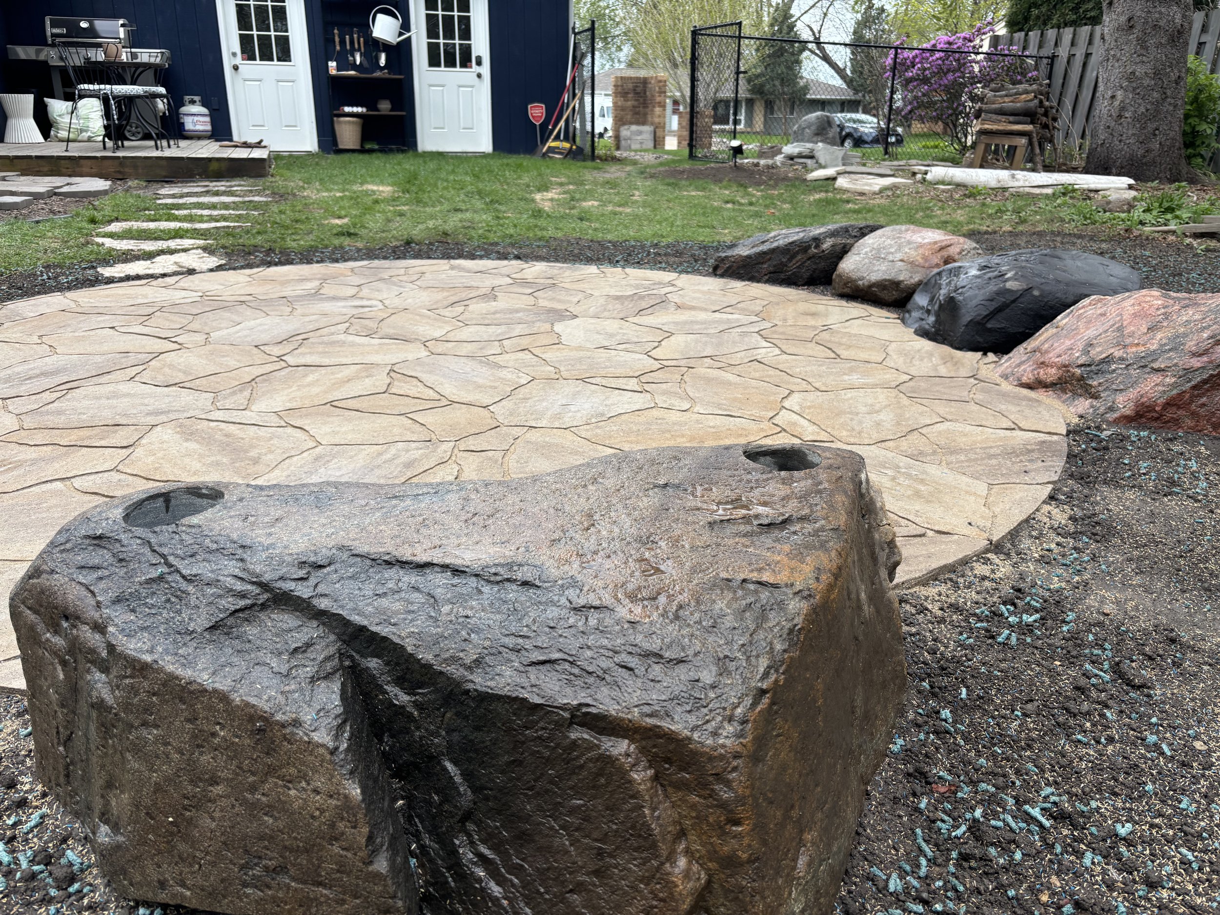 Stanley project round paver patio with boulder seating, Relentless Landscaping