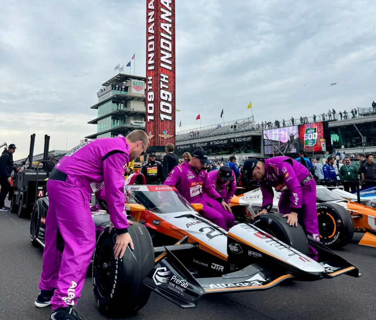 Indy 500 race team preparing a car near the starting grid