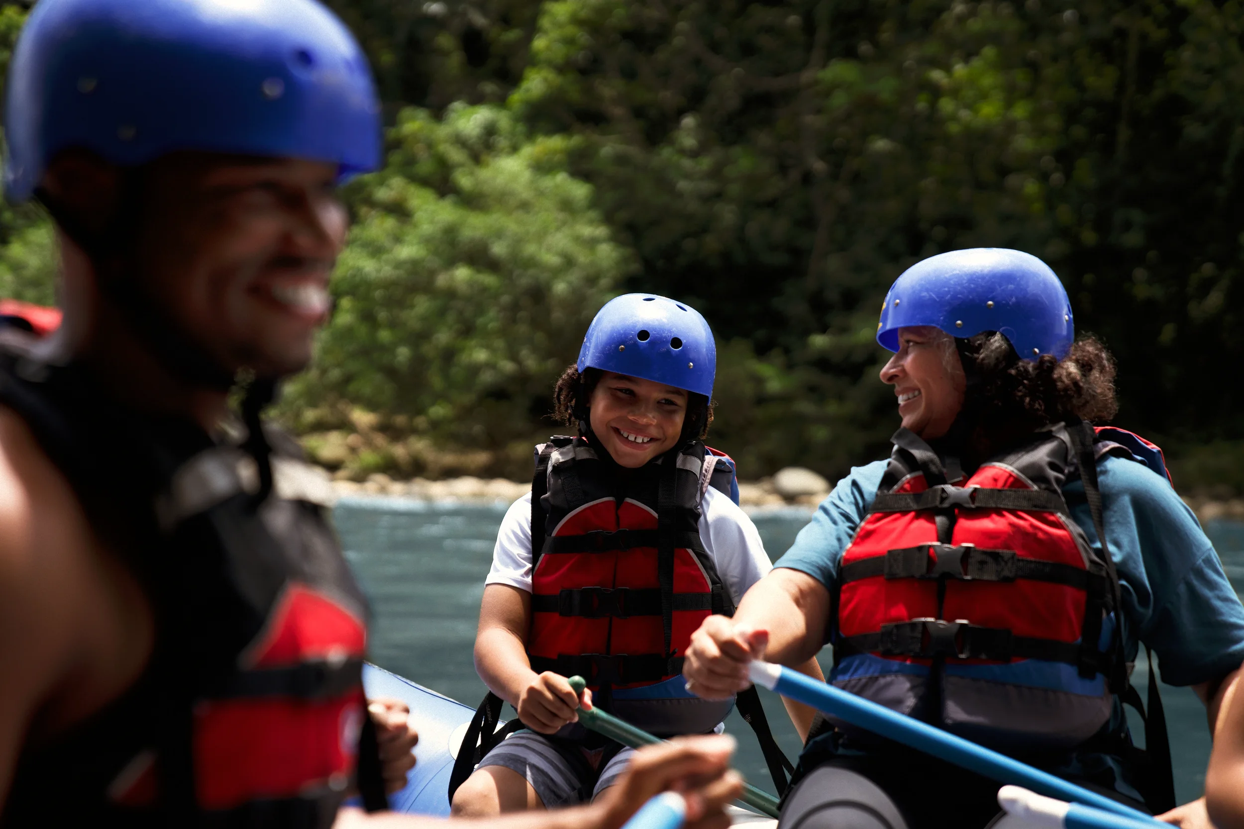 Family rafting during an Adventures by Disney vacation