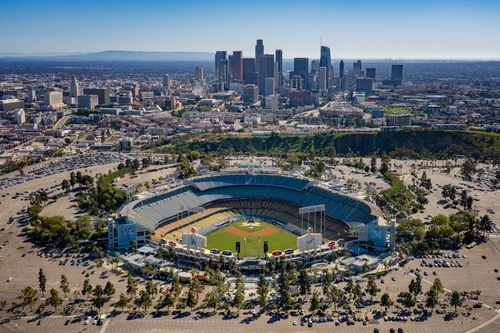 Aerial view of Dodger Stadium and the Los Angeles skyline representing Summer Games travel