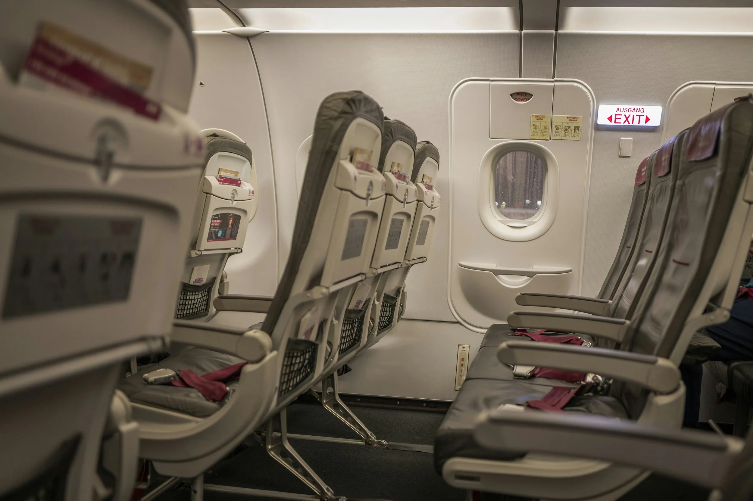 Airplane exit row seating with additional space near the emergency exit