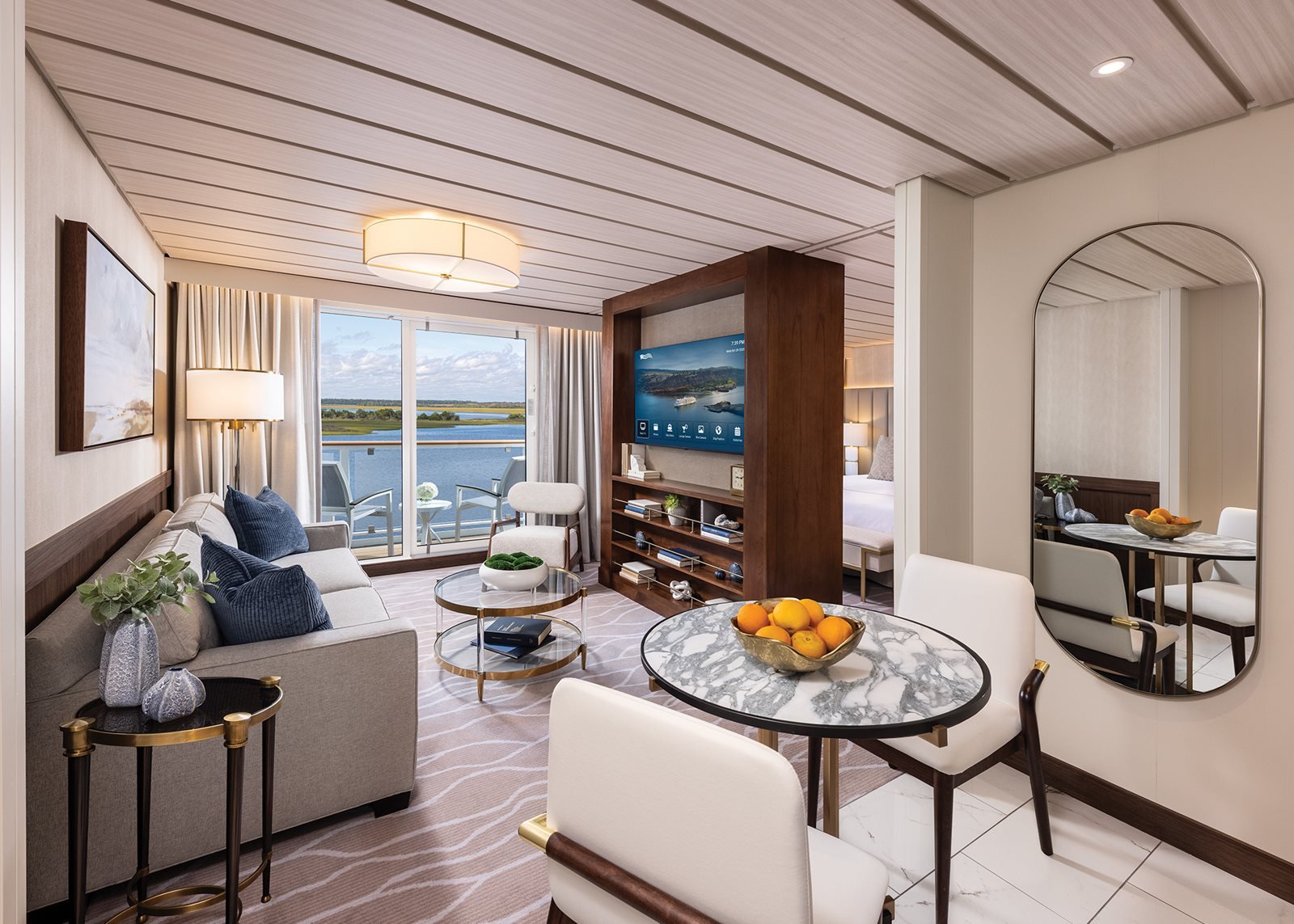Spacious American Cruise Lines suite with seating area and large windows