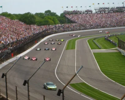 Indy cars racing before packed grandstands at Indianapolis Motor Speedway