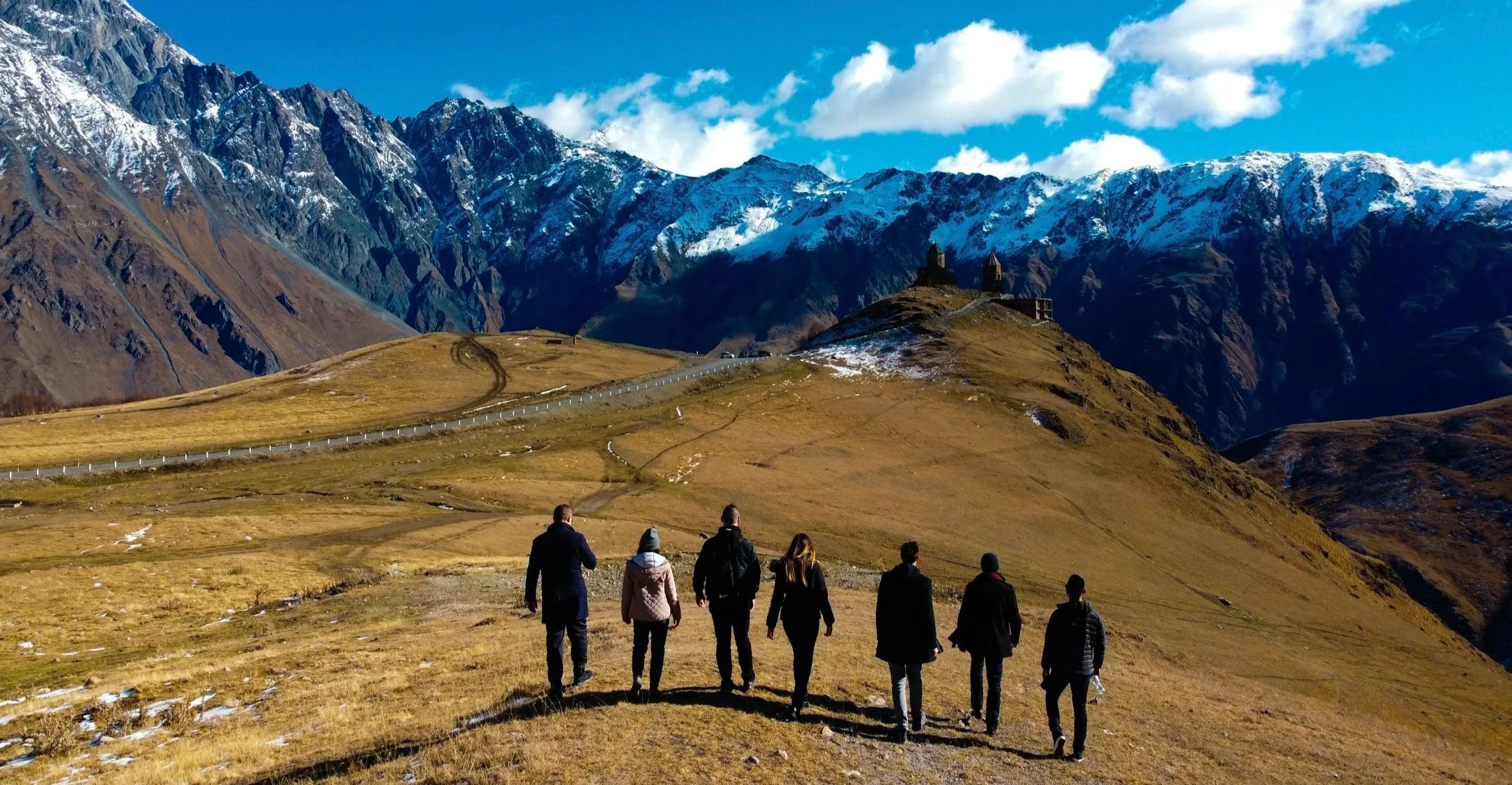 Group of travelers hiking together on a scenic trail