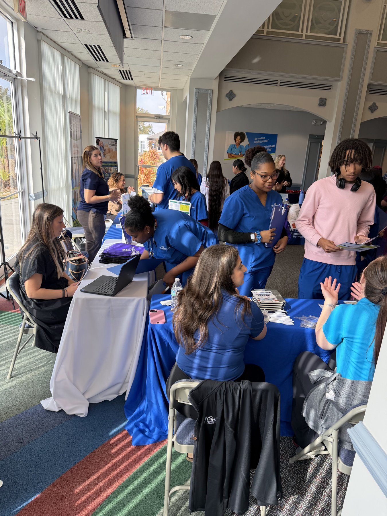 Medical Assisting and Veterinary Assisting students interacting with employers at covered recruiting tables during a Southern Technical College career fair.
