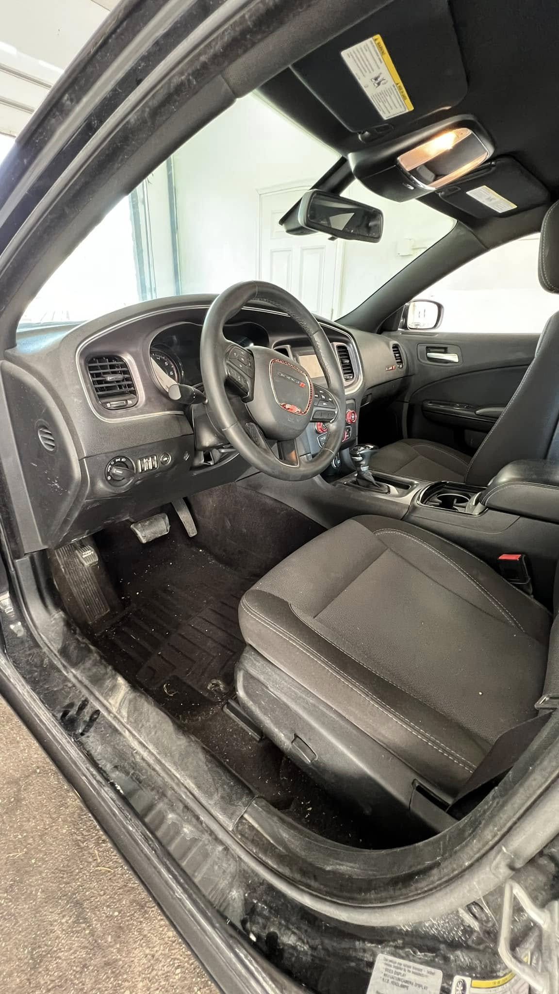 Dirty car interior with heavy buildup before cleaning