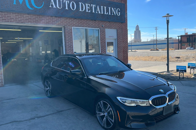 MC Auto Detailing shop exterior at 2043 O Street Lincoln NE near UNL campus with detailed BMW out front