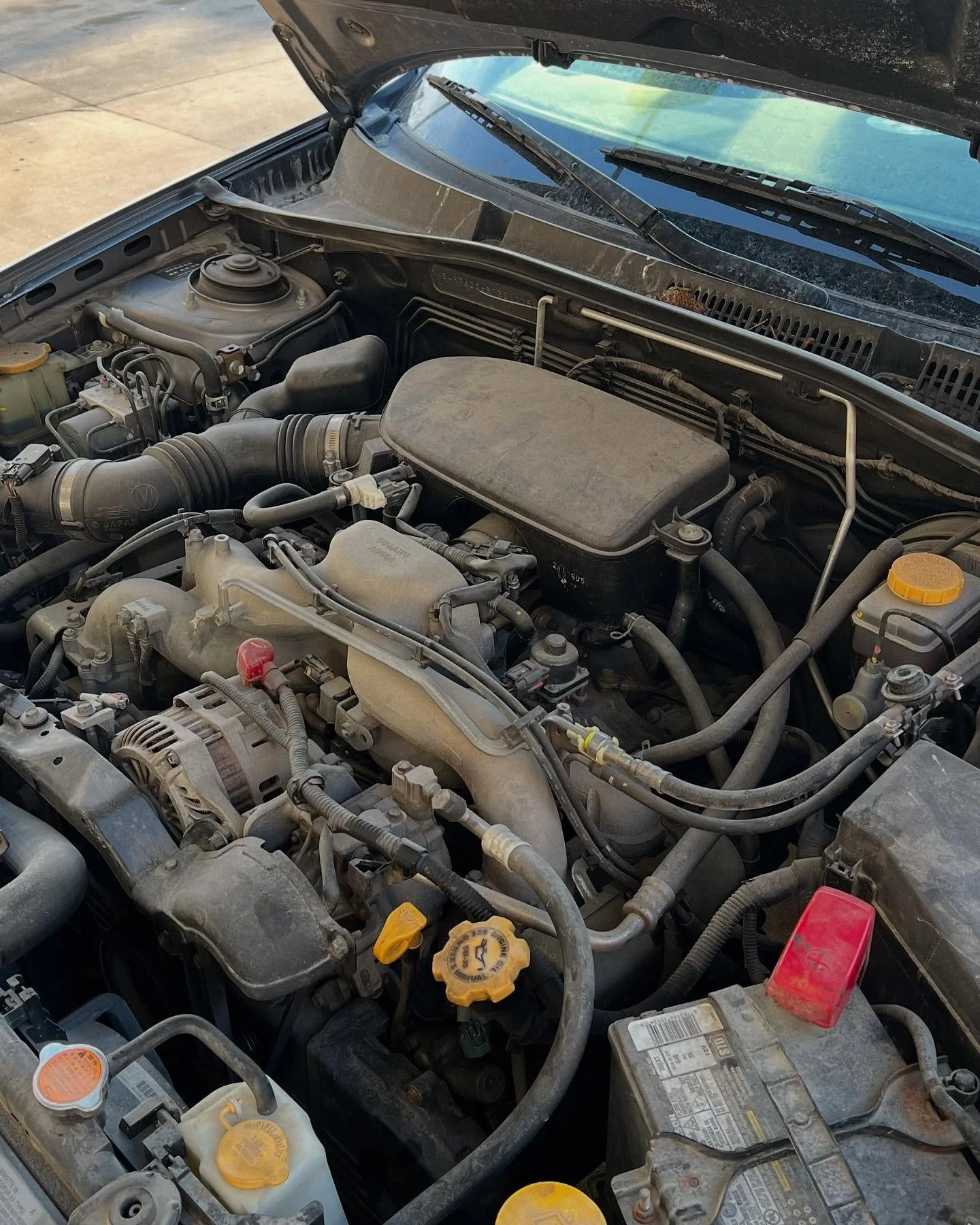 Engine bay before cleaning with road grime and dust build-up – Lincoln Nebraska