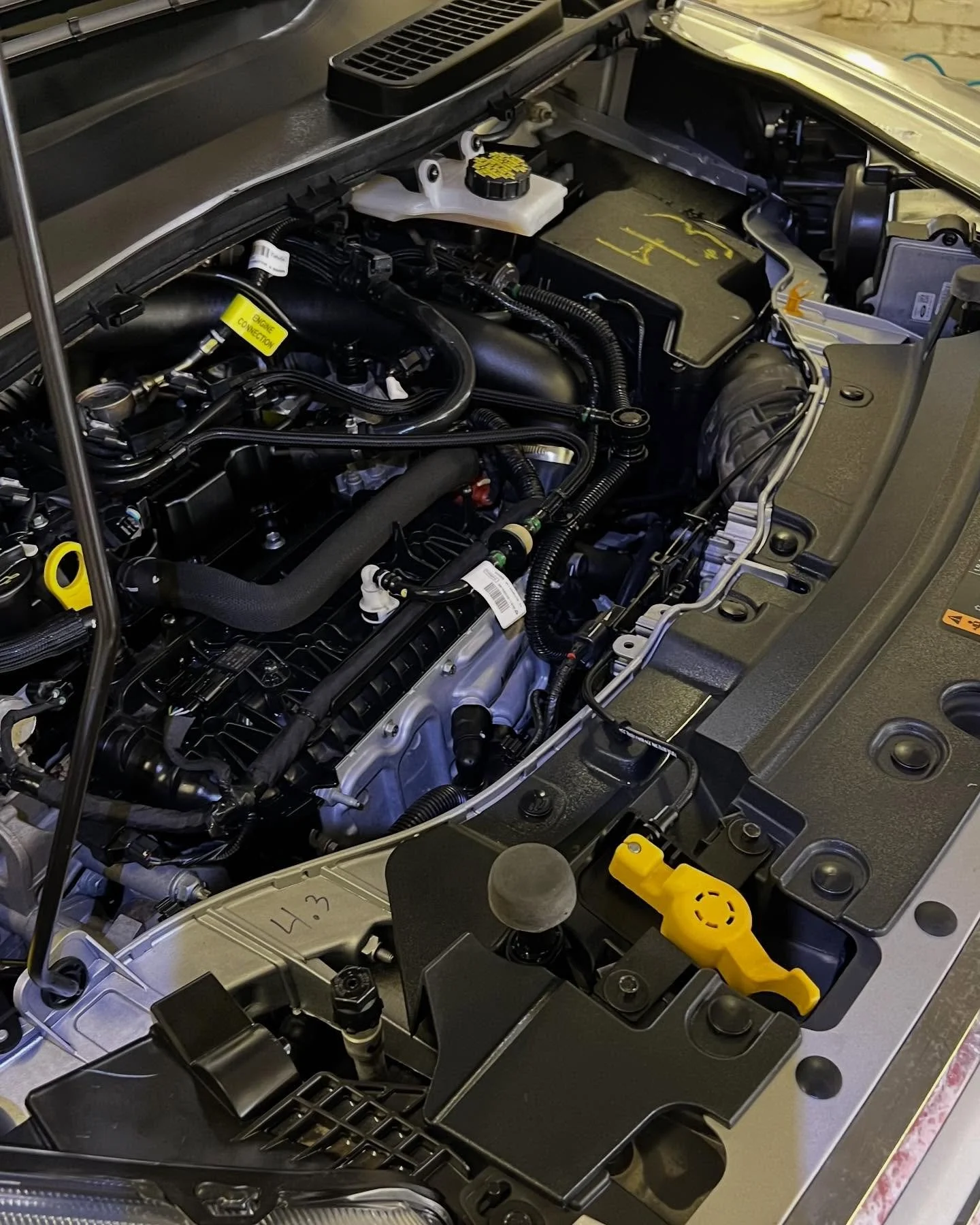 After engine bay cleaning: clean plastics, dressed hoses, and tidy components – Lincoln Nebraska detail shop