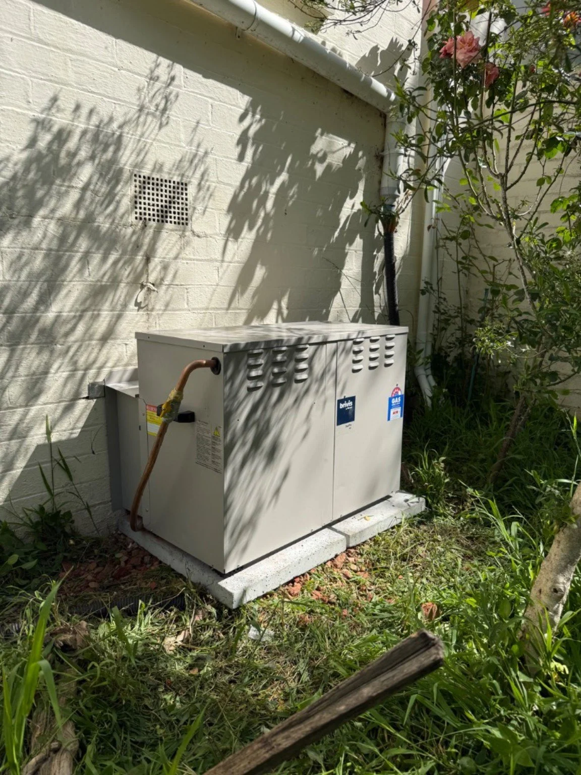 Pro-Tech gas ducted heater installation beside a brick wall