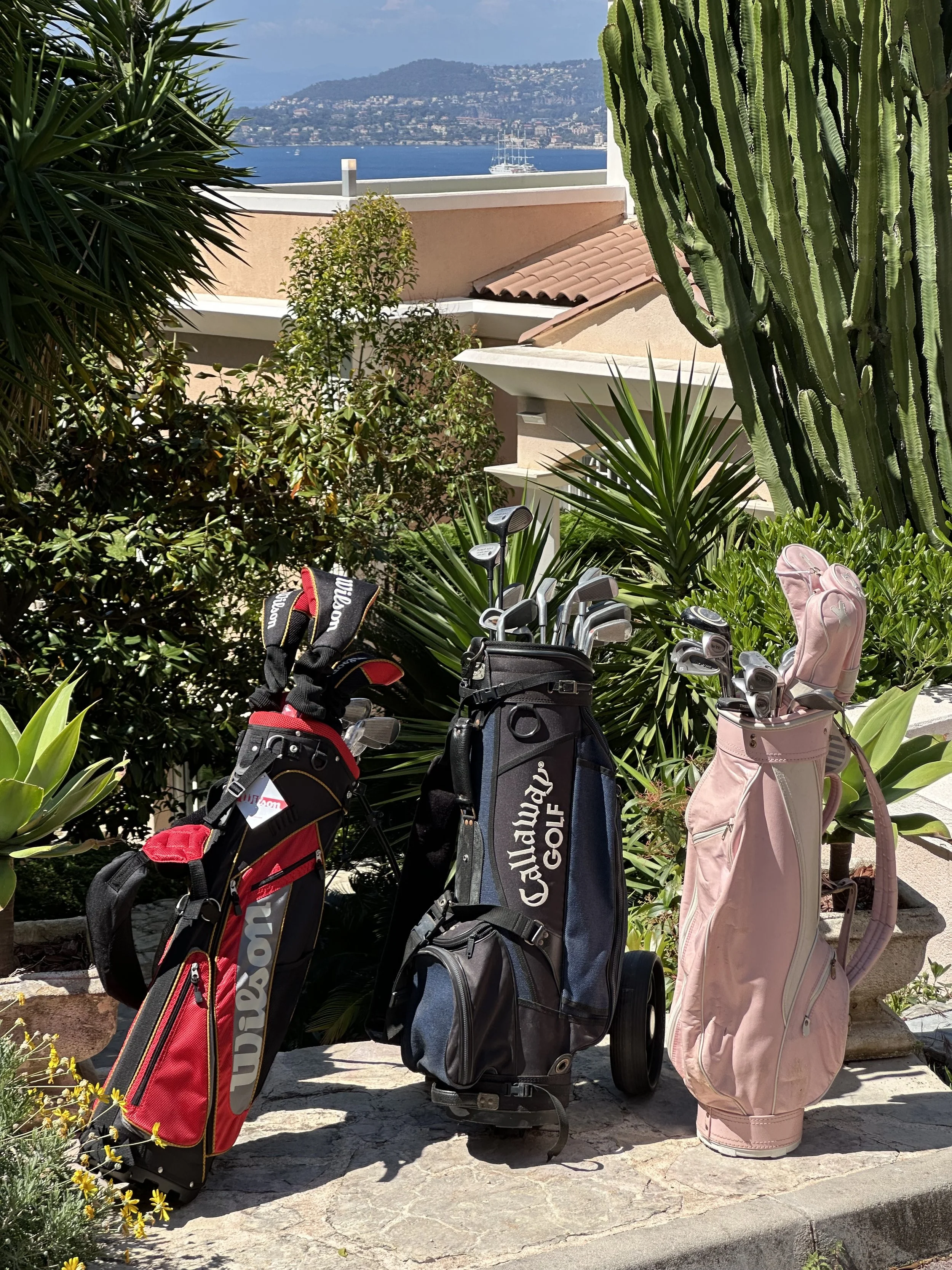 Golf clubs and bags ready by Villa Monaco's entrance for a morning tee time at the Monte-Carlo Golf Club