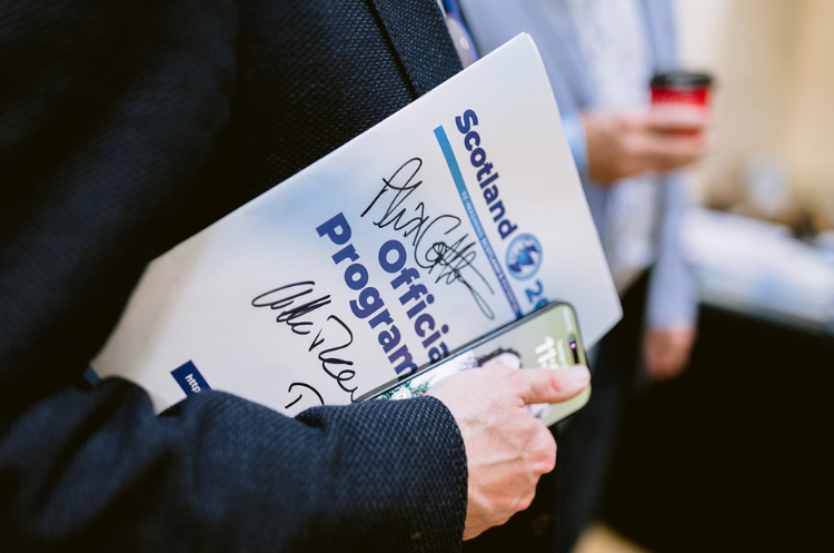 A delegate holding the signed Scotland 2050 official programme