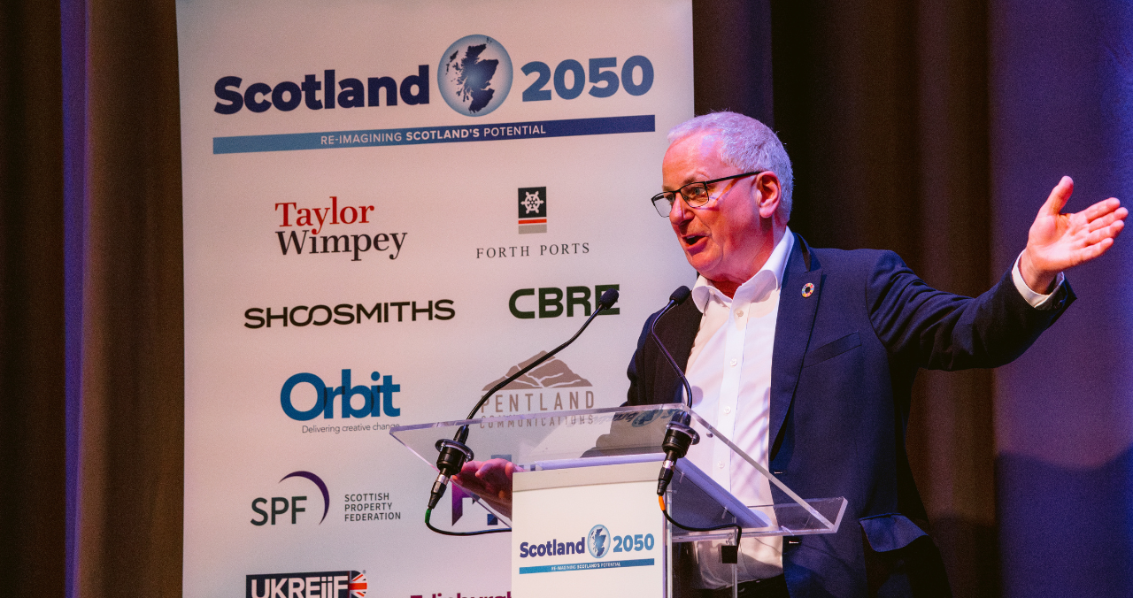 Lord Jack McConnell speaking at the podium