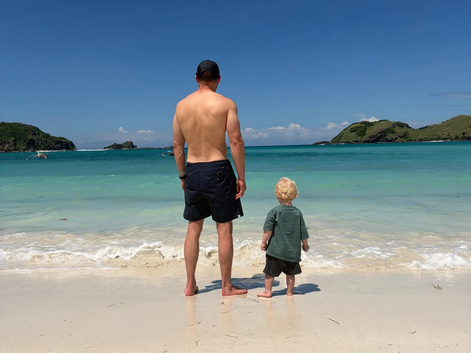 Father and son on a quiet beach in South Lombok
