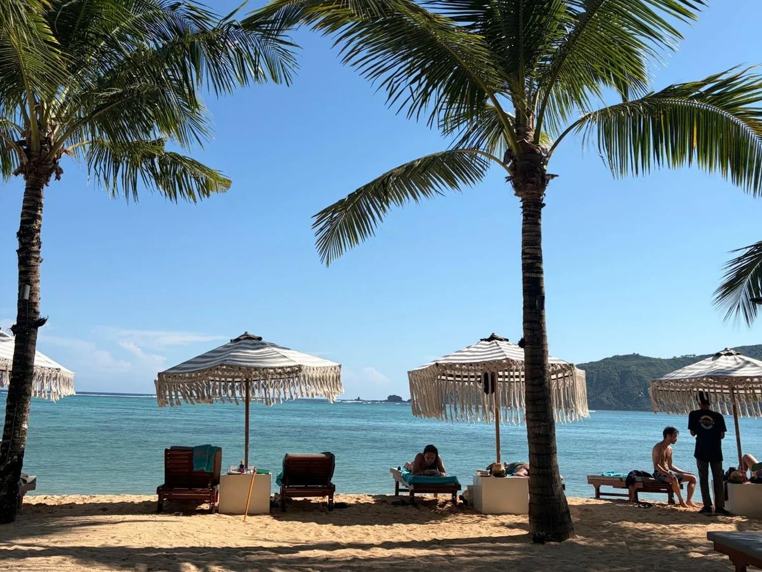 Beach with palm trees and parasols at Kuta Lombok