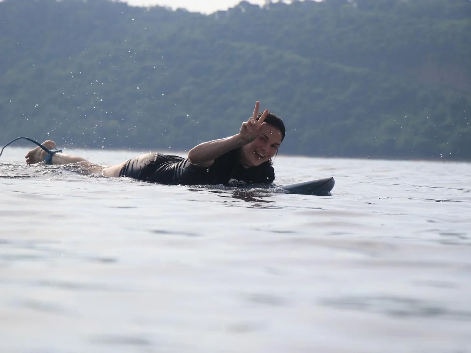 Surfer paddling out at Gerupuk, South Lombok