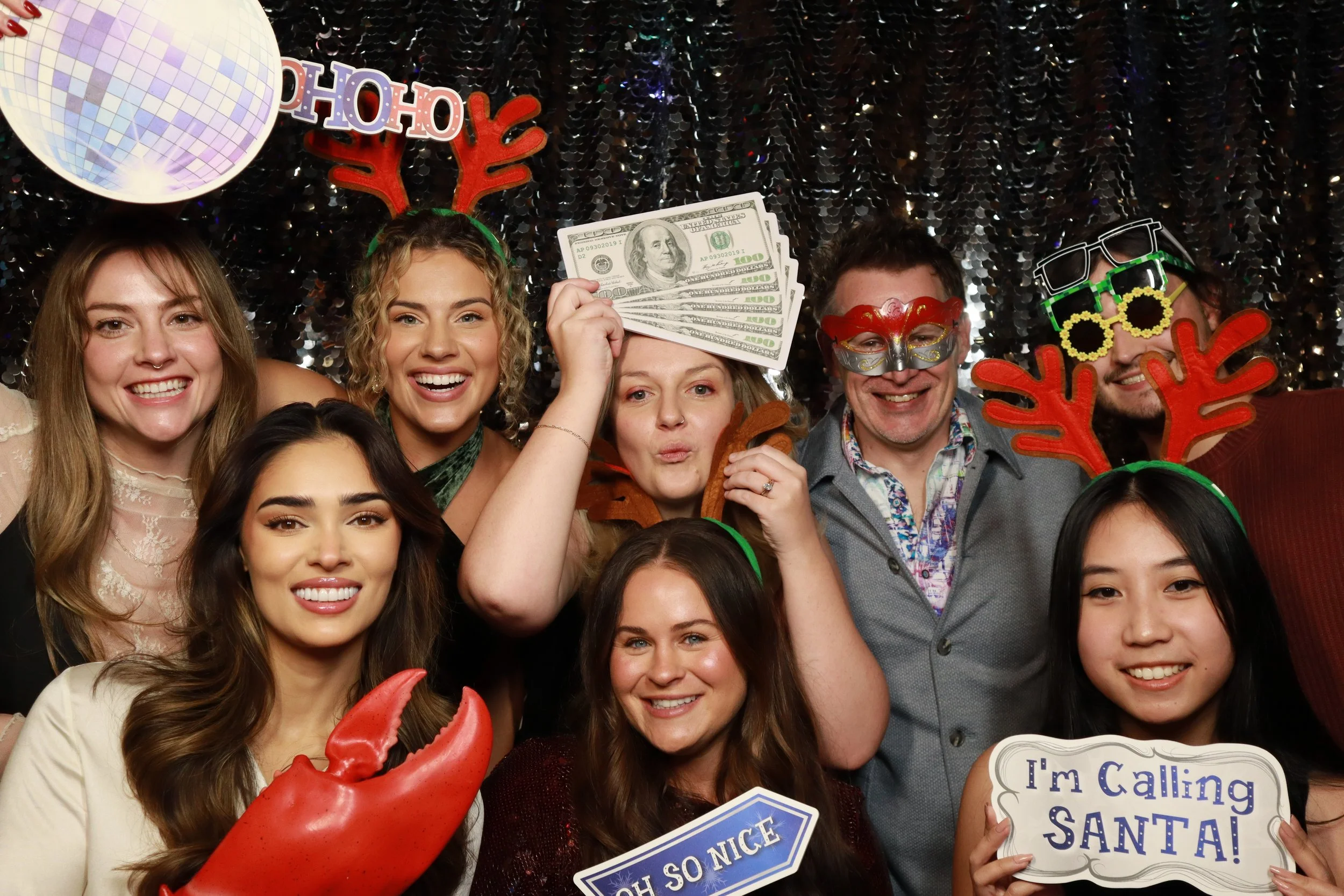 Guests at a holiday party photo booth