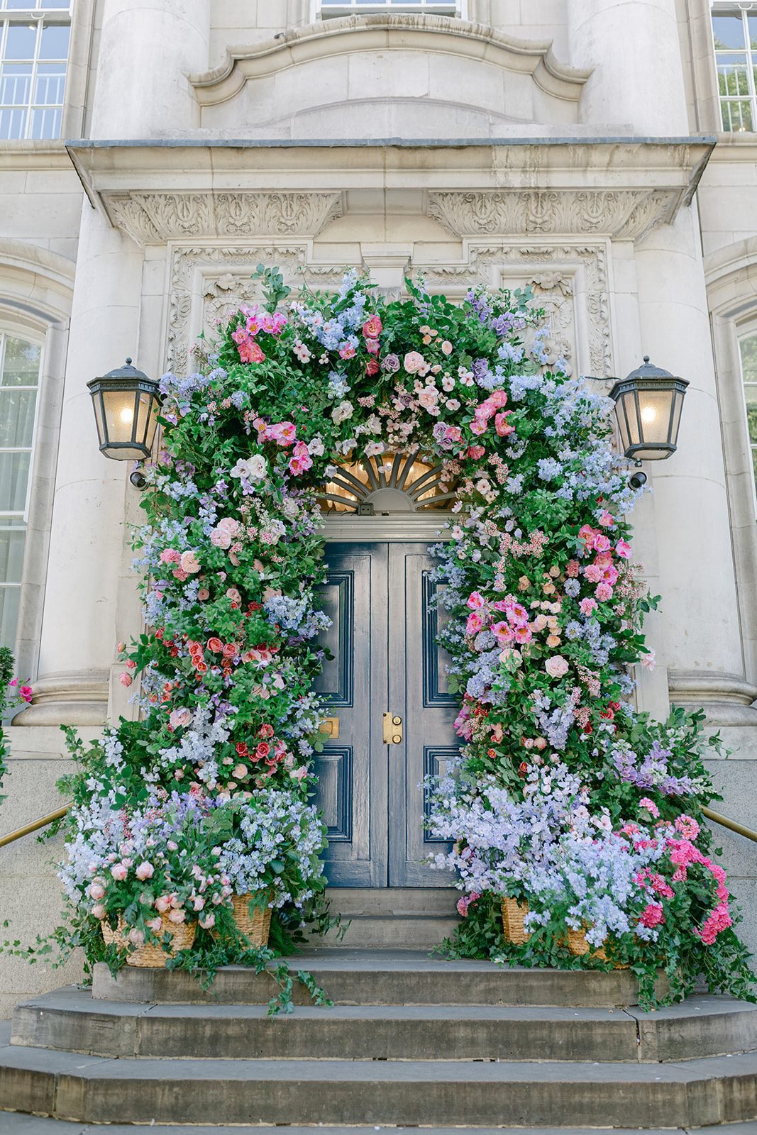 Hanging floral baskets cascading from the Chelsea in Bloom archway in central London