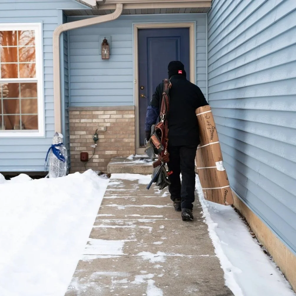 hand pressing against cold front door on winter day