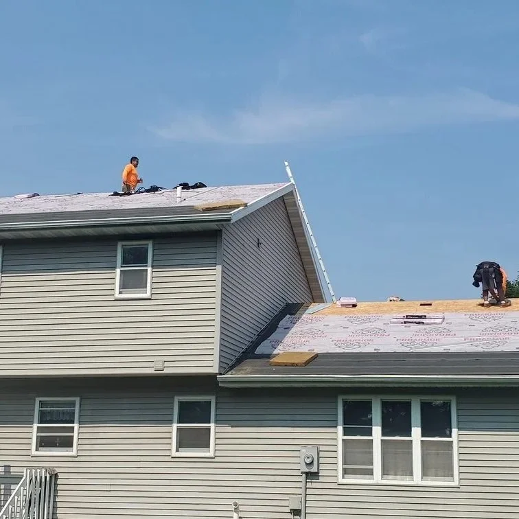 fresh asphalt shingles being installed on snowy roof