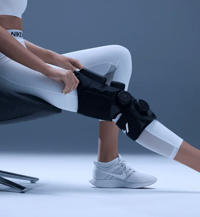 Person wearing a Hyperice X 2 contrast therapy device on the knee