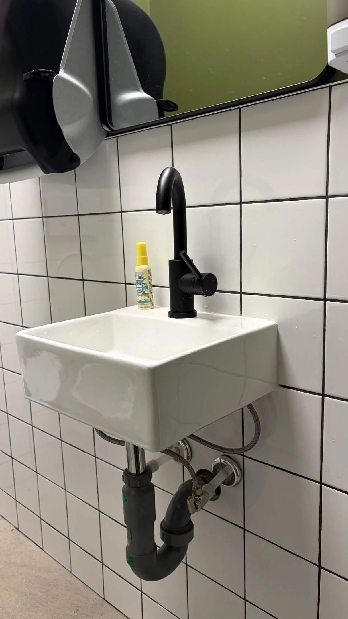 Washroom sink with matte black faucet — commercial plumbing