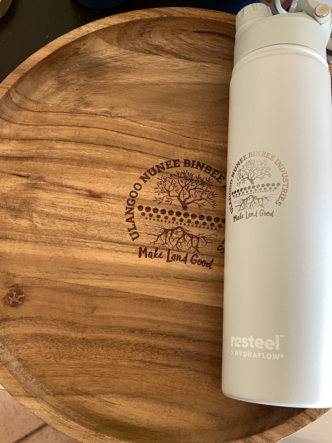 Engraved wooden board and white bottle